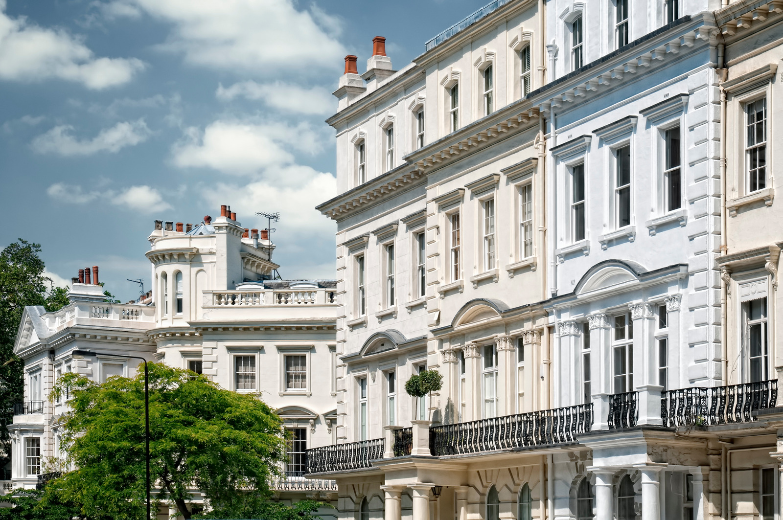 Elegant white stucco-fronted townhouses in Central London, ideal for landlords looking to secure prime tenants discreetly.